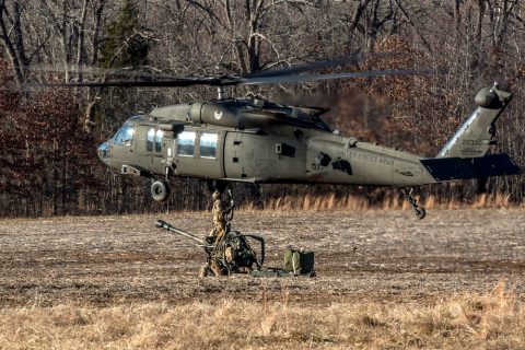 Artillerymen from B Battery, 3rd Battalion, 320th Field Artillery Regiment, 101st Airborne Division Artillery Brigade, 101st Airborne Division (Air Assault), rig an M119A3 howitzer to a UH-60 Black Hawk helicopter before conducting air assault operations, January 24, 2018, at Fort Campbell, Kentucky. Sling loading the howitzers allows the artillerymen to occupy remote locations more rapidly to effectively fire upon the enemy. (Spc. Patrick Kirby, 40th Public Affairs Detachment) 