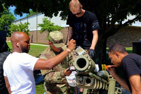 Pfc. Quadry Wilson, Spc. Fenando Carbajal Montes, Spc. Nicholas Johnston and Pvt. Jayson Taylor prime a 105mm M3 Airborne howitzer for repainting, 29 June, at the Don F. Pratt Memorial Museum on Fort Campbell, Kentucky. (Pfc. Lynnwood Thomas, 40th Public Affairs Detachment) 