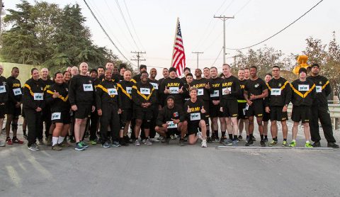 Soldiers of the 101st Resolute Support Sustainment Brigade gather around Col. Stephanie Barton, the Commander of the 101st Resolute Support Sustainment Brigade, and Command Sgt. Maj. Anthony McAdoo, the senior noncommissioned officer of the brigade, before participating in the 101st Lifeliner SHARP five kilometer run at Bagram Airfield, Afghanistan, Oct. 18, 2018. (1st Lt. Verniccia Ford, 101st Airborne Division (AA) Sustainment Brigade Public Affairs)