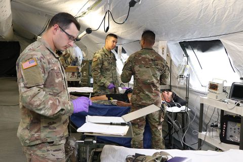Sgt. Damien Colliver, Spc. Keith Gaston and Capt. Mark Cenon, all from the 41st Medical Detachment on Fort Campbell treat a simulated casualty in the new Intensive Care Unit of 586th Field Hospital during a training exercise on post. The two-week field exercise was the first for the 531st Hospital Center and seven of its direct reporting units since transitioning from the 86th Combat Support Hospital to the Army's new field hospital platform. (U.S. Army photo by Maria Yager)