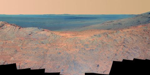 This May 14, 2014, scene from the Pancam on NASA's Mars Exploration Rover Opportunity catches "Pillinger Point," on the western rim of Endeavour Crater, in the foreground and the crater's eastern rim on the horizon. (NASA/JPL-Caltech/Cornell Univ./Arizona State Univ.)