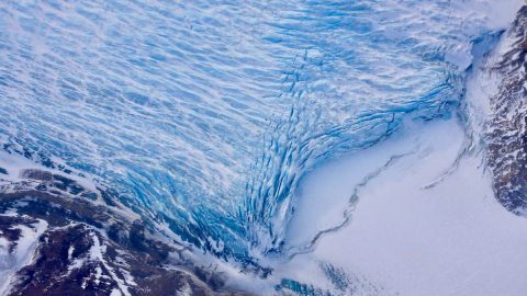 Cracks in the front of a glacier as it reaches the ocean. (NASA/Adam Klein)