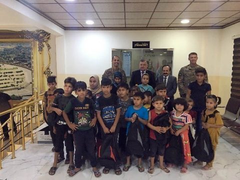 Lt. Col. Trevor Voekel and Command Sgt. Maj. Eddie Brewer of 1st Battalion, 327th Infantry Regiment pose for a photo with local children and the mayor of Mosul in Mosul, Iraq, Sept. 10, 2019. Task Force Ninewah donated 500 backpacks to the Mosul Mayor’s office to distribute to children within the town. The U.S. Soldiers from the 101st Airborne Division are deployed from Fort Campbell, Kentucky. (Maj. Vonnie Wright, 1st Brigade Combat Team, 101st Airborne Division (AA) Public Affairs)