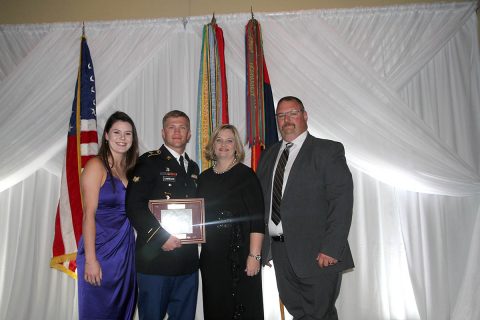 Spc. William Lawrence receives award at the Fort Campbell Chapter - Association of the United States Army Guardian's Gala by Maj. Gen. Brian E. Winski on Oct. 24 for his extraordinary actions taken as a combat medic during Operation Inherent Resolve. Spc. Lawrence stands with his parents at the conclusion of the event. From left Meghan Smith, U.S. Army Spc. William Lawrence, mother Linda Hicks, and stepfather Chris Hicks. (Maj. Vonnie Wright)