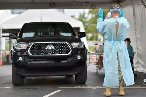 Staff Sgt. Carl Terry guides a vehicle at the Nissan Stadium testing site, in downtown Nashville, Aug. 21.  Since March, over 2,000 Tennessee National Guardsmen have been activated in some capacity to assist their communities in the fight against COVID-19. (Staff Sgt. Timothy Cordeiro)