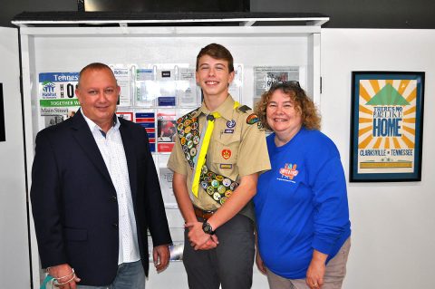 (L to R) HFHMCTN Executive Director Rob Selkow, Eagle Scout Taydan Jackson, and Loaves & Fishes Executive Director Rita Burnett stand in front of the Community Kiosk.