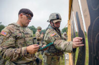 Tennessee National Guardsmen and Active Duty Army personnel work together to tally scores, Aug. 22, during the TAG Pistol Match at Tullahoma’s Volunteer Training Site. The TAG Match is an annual marksmanship competition and training event hosted by the Tennessee Combat Marksmanship Program. (Pfc. Olivia Gum)