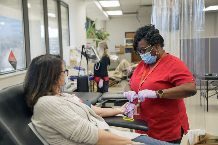 Red Cross phlebotomist Malinda Majors works with whole blood donor Carlene Gray in preparation for her donation. (Adam Chapman, American Red Cross)