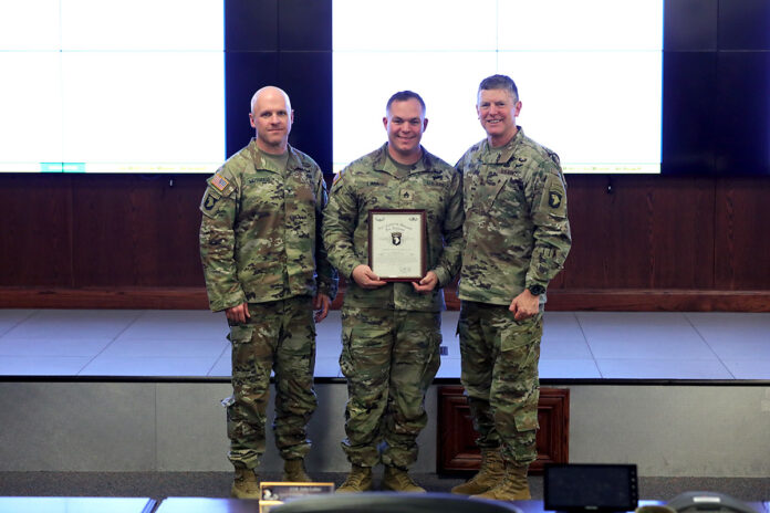 Staff Sgt. Samuel Lima, a squad leader with Bravo Troop, 1st Squadron, 75th Cavalry Regiment, 2nd Brigade Combat Team, 101st Airborne Division (Air Assault) (center), receives a Certificate of Appreciation from Maj. Gen. JP McGee, commanding general, 101st Airborne Division (AA) (right) and Col. Ed Matthaidess, commander, 2nd BCT (left), during the cohesion roundtable at Fort Campbell, KY, March 29th, 2022. Lima was recognized for his contributions towards Soldier Holistic Health and Suicide Prevention. (Spc. Jordy Harris, 101st Airborne Division)