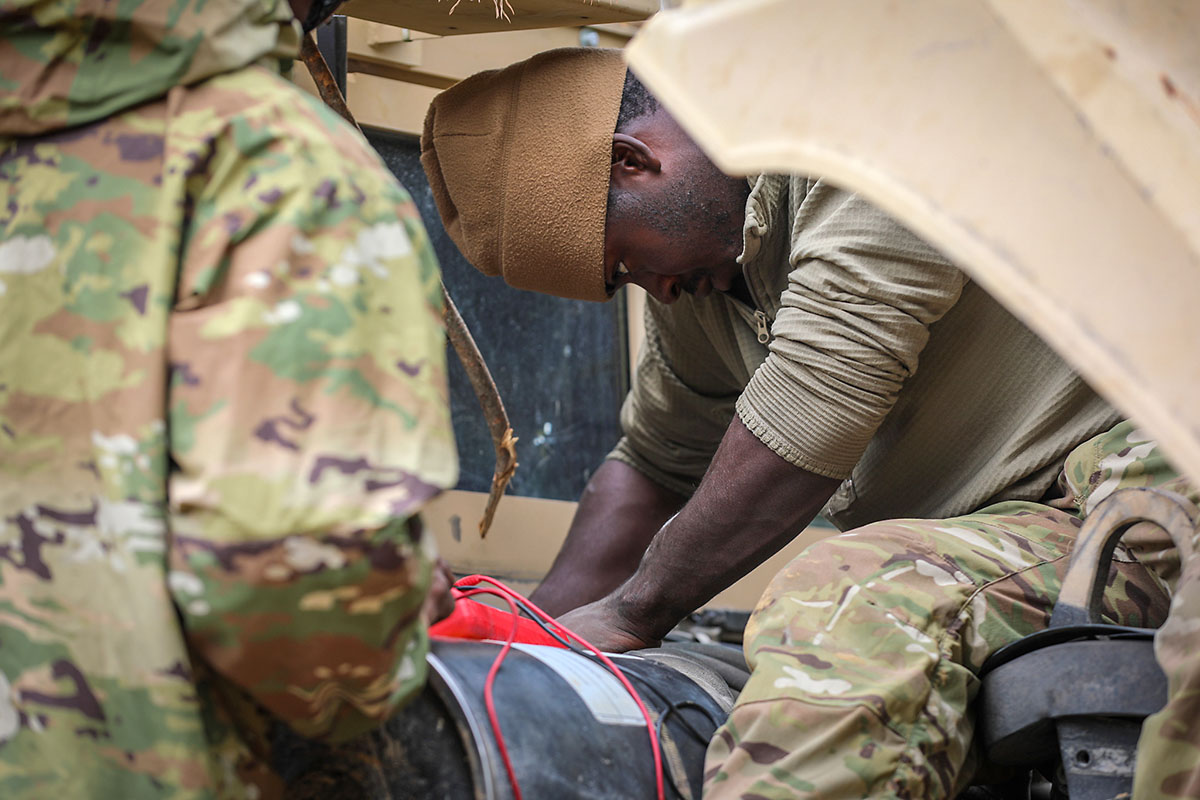 Spc. Maruh Massaquoi, a wheeled vehicle mechanic with E Forward Support  Company, 21st Brigade Engineer Battalion, 3rd Brigade Combat Team, 101st  Airborne Division (Air Assault), works to repair a military vehicle during
