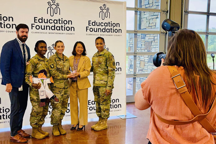 Northeast Middle School Principal Evan Stinson, joined Blanchfield Army Community Hospital Partners in Education representatives Sgt. Ashley Gardner, Sgt. 1st Class Jamie Hendzel, and Staff Sgt. Sierra Brown in accepting the 2022 Boots on the Ground award from Clarksville-Montgomery County Education Foundation Chairman Jo Dee Wright, during an appreciation breakfast in Clarksville, Tennessee, Aug. 30. The foundation presents the annual Boots on the Ground award to the top military unit or veteran group participating in its Partners in Education program, which matches local businesses and organizations with schools in the Clarksville-Montgomery County School System. (Maria Yager)
