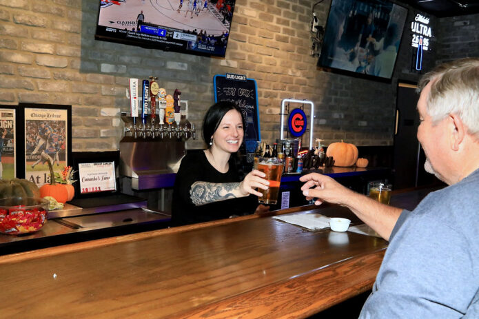 Camacho’s Famous’ Victoria Armstead serving up food and drinks to Mike Roberts. (Tony Centonze, Clarksville Online)