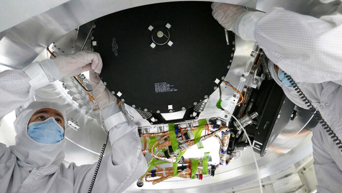 Engineers install 2-foot-wide reaction wheels onto the main body of NASA’s Europa Clipper spacecraft at the agency’s Jet Propulsion Laboratory. The orbiter is in its assembly, test, and launch operations phase in preparation for a 2024 launch. (NASA/JPL-Caltech)