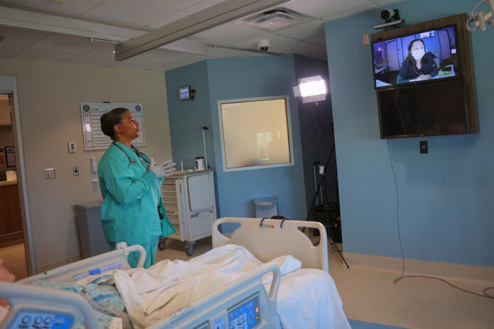 Blanchfield Army Community Hospital Intensive Care Unit Chief Nurse Maj. Brenda Mitchell preforms a communication check on Fort Campbell, Kentucky, with a nurse at the Defense Health Agency Virtual Medical Operations Center, Naval Medical Center San Diego, California, using the Joint Tele Critical Care Network, March 27. The JTCCN virtually integrates highly skilled critical care physicians, or intensivists, from DHA medical centers, or “hubs”, like Naval Medical Center San Diego and Brook Army Medical Center, with “satellite” intensive care units at nearly 20 military treatment facilities worldwide.