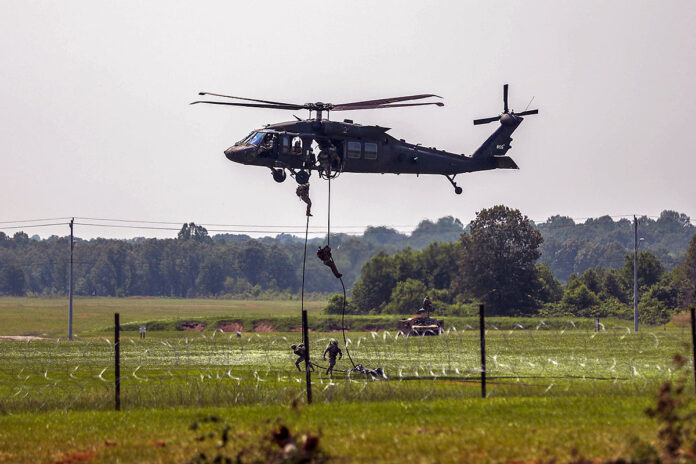 Soldiers assigned to the 101st Airborne Division (Air Assault) fast rope out of a UH-60 “Blackhawk” during the Week of the Eagles Air Assault Demonstration on Fort Campbell, KY, May 21st, 2023. The theme for this year’s Week of the Eagles event is “Celebrating 80 years of excellence”. (Pfc. Matthew Wantroba, 101st Airborne Division)