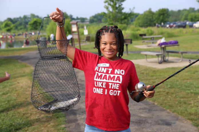 Kenedi Smiling with the first fish she has ever caught. (Mark Haynes, Clarksville Online)