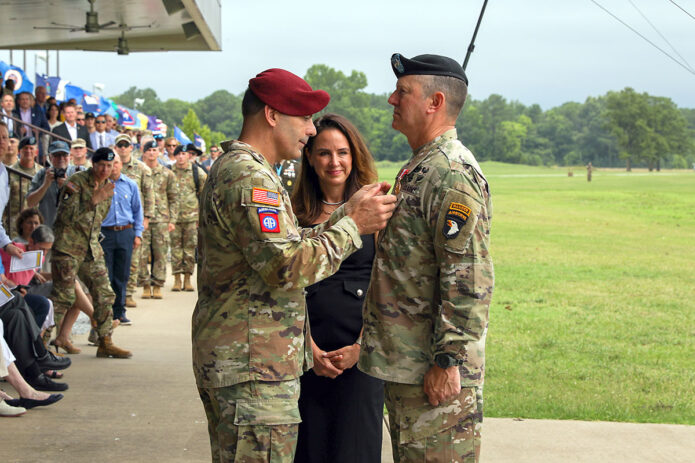 Lt. Gen. Christopher Donahue, commander of XVIII Airborne Corps, awards Maj. Gen. JP McGee, outgoing commander of the 101st Airborne Division (Air Assault), with the Distinguished Service Medal at Fort Campbell, Ky., July 20, 2023. McGee relinquished command to incoming commander Maj. Gen. Brett Sylvia during the division Change of Command ceremony following. (Sgt. Andrea Notter, 101st Airborne Division)