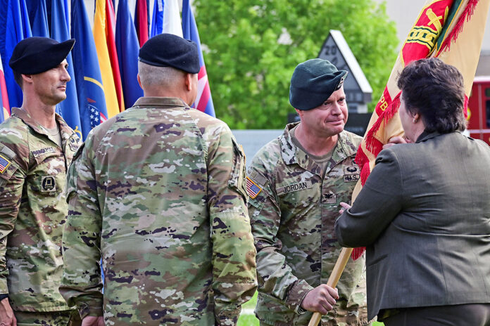 Col. Andrew Q. Jordan, outgoing Fort Campbell garrison commander, passes the garrison’s guidon to Ms. Brenda Lee McCullough, former director, U.S. Army Installation Management Command, during a change of command ceremony, Aug. 16, at the Memorial Row at Fort Campbell.