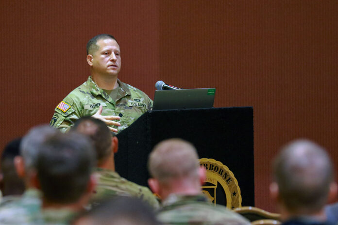 Lt. Col. John Lesher, holistic health and fitness physical domain lead, discusses the Army's Holistic Health and Fitness program at Cole Park Commons, Fort Campbell, Ky., September 26th, 2023. Fort Campbell is hosted the XVIII Airborne Corp's H2F symposium September 26th-29th, 2023, to educate senior leaders about the program and its benefits. (Spc. Jayden Woods)