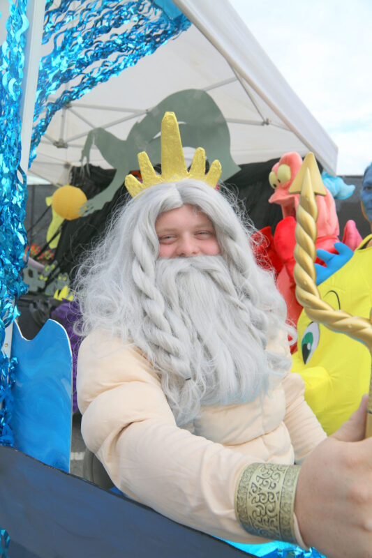 Parker Denton as King Triton from The Little Mermaid, handing out candy at the Harris Psychological Services tent