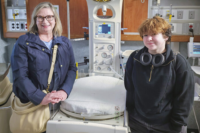 Former 101st Baby, Ash Morgans (right), and her foster mother, Sarah Morgans, stand in the Labor and Delivery department at Blanchfield Army Community Hospital, March 2024, where Ash was born 18 years ago. (Justin Moeller, Blanchfield Army Community Hospital)